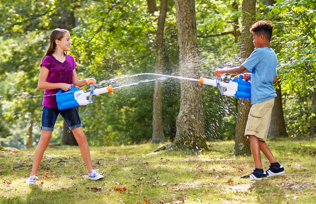 Kids blasting water at each other using Nerf guns