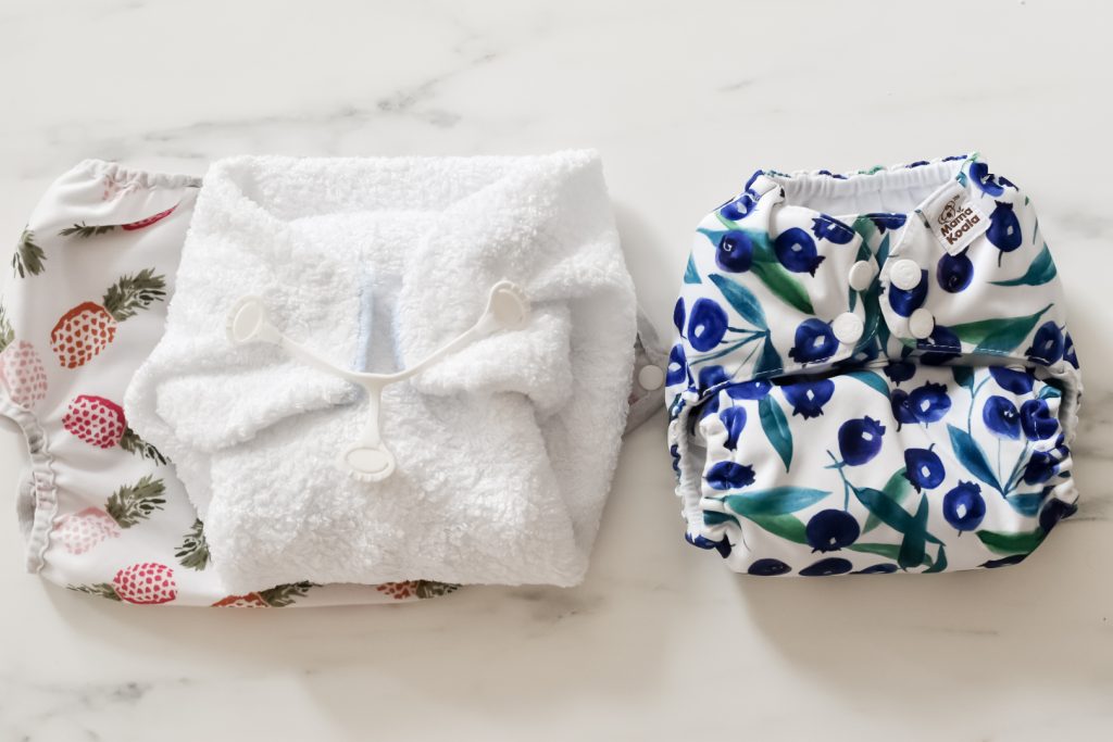 Terry square (left) next to modern cloth nappy (right)