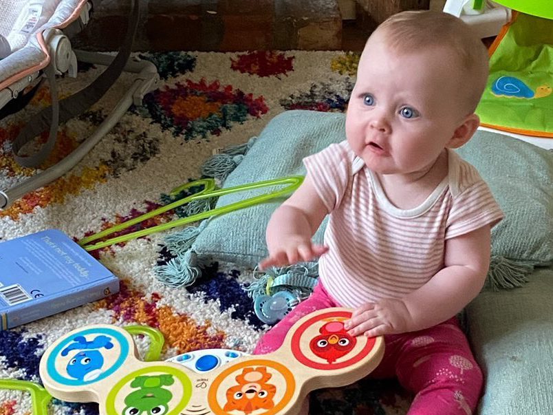 A Whirli user plays with the Hape Baby Einstein Magic Touch Drums